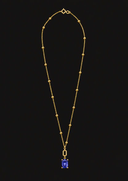 Logo Knot Beaded Tanzanite Necklace in 18K Gold — black background product cover