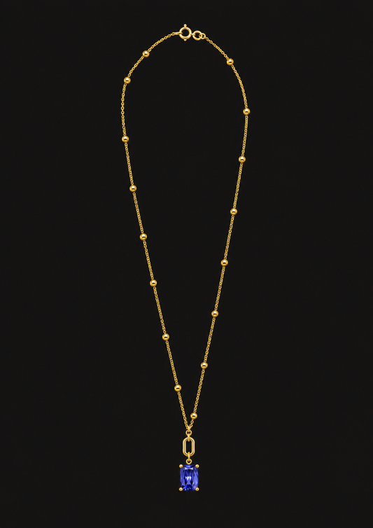 Logo Knot Beaded Tanzanite Necklace in 18K Gold — black background product cover